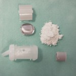 Figure 9 The contents of a capsule: 1. Plastic clip 2. Pillow 3. Powder 4. Access hole 5. Outer casing 6. Plunger