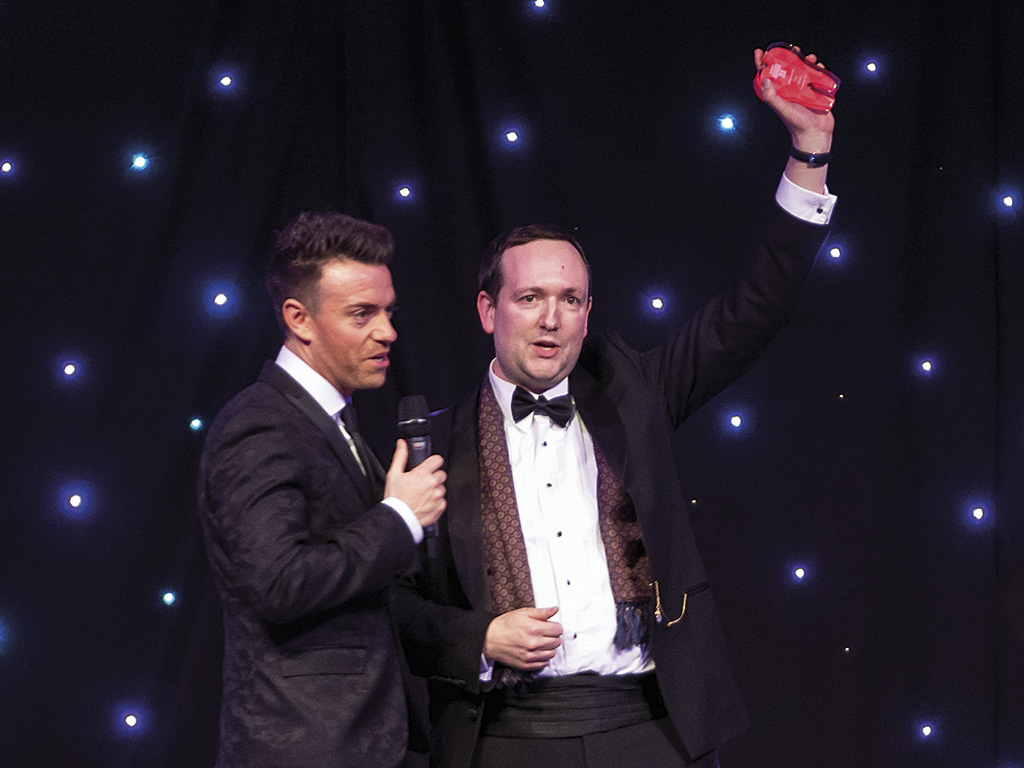 Mike Gow on stage with Des Clarke at the 2018 Scottish Dental Awards