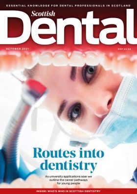 Routes into dentistry - the October 2021 cover is a female dentist holding a handpiece looking into an open mouth