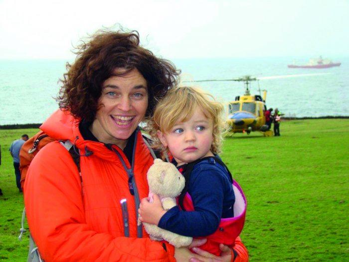 Penny grainger carrying her daughter Elika on arrival by helicopter on Tristan da Cunha