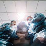 A dental team get to work, photographed from below the chair