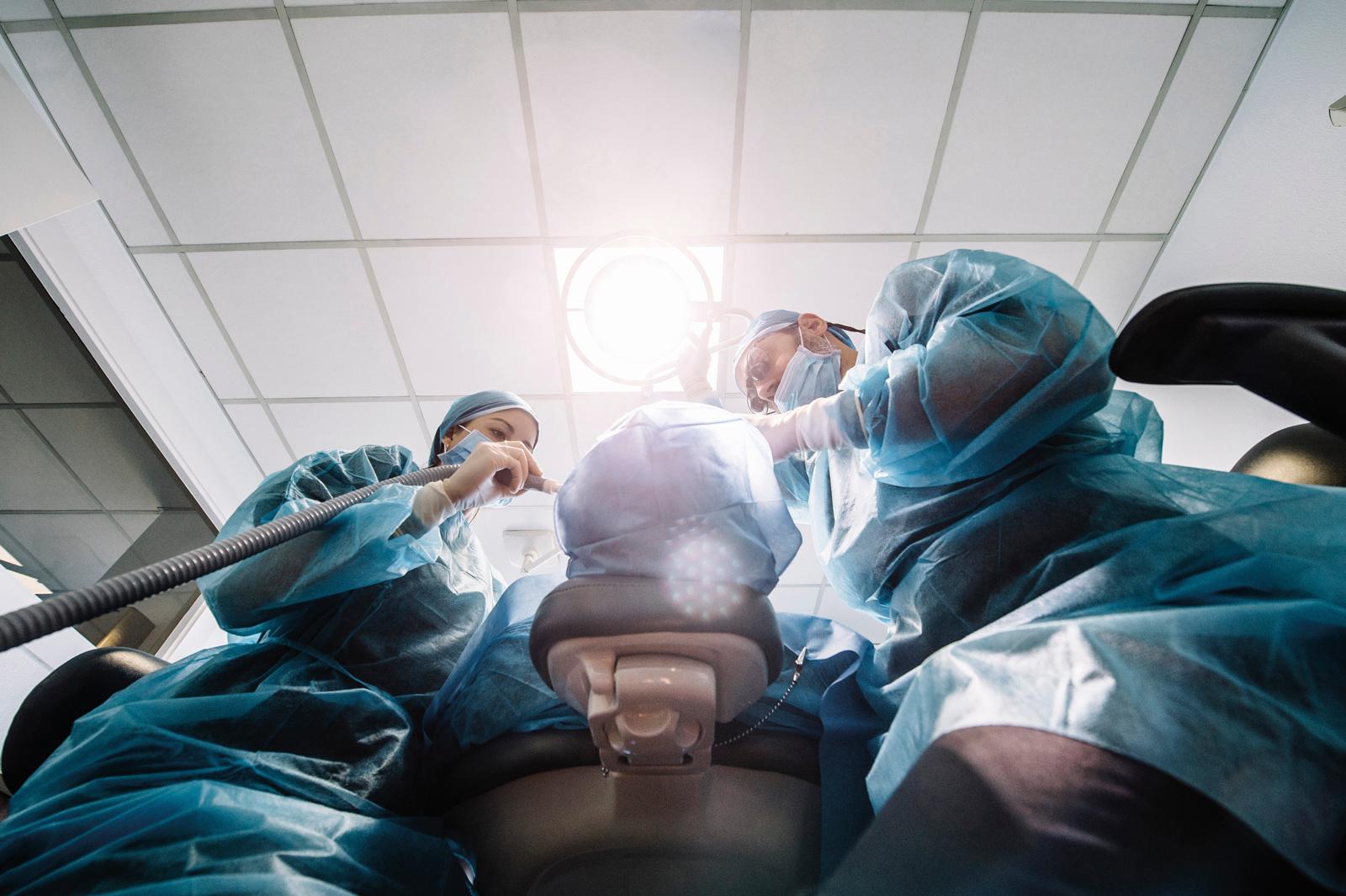 A dental team get to work, photographed from below the chair