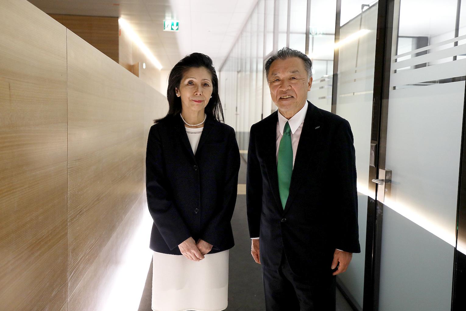 Mr and Mrs Nakao photographed in a modern corridor