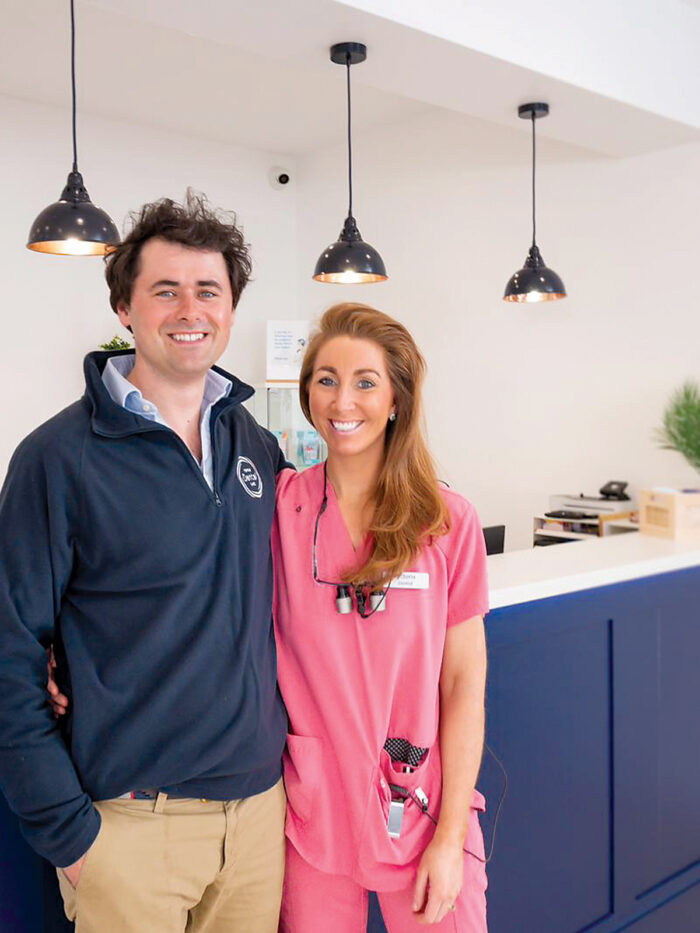Ian and Victoria pose for a picture in front of the reception desk at Forfar Dental Care.